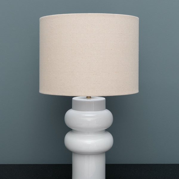 White lamp curve with beige linen shade 