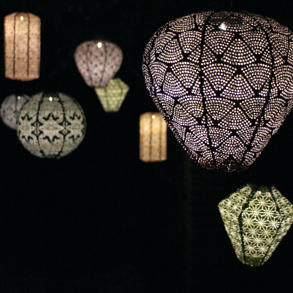 solar garden lanterns lit at night 