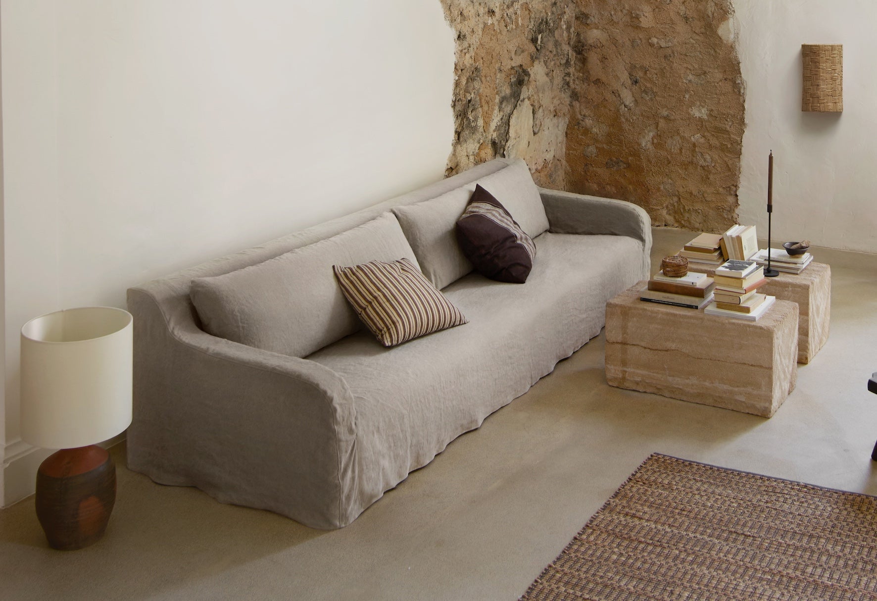 Modern rustic living room with natural textures, cushions and wood furniture by Tine K Home