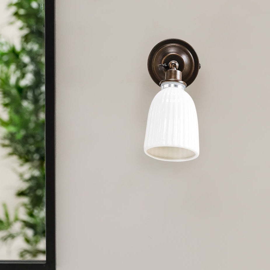 Alma bronze and white glass bathroom wall light 