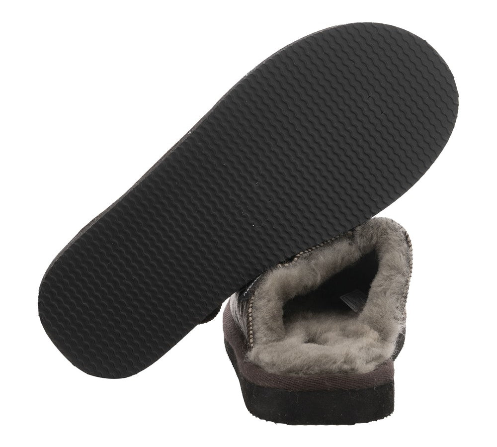 Grey sheepskin slipper with black sole on a white background