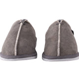 Pair of gray slippers with white soles on a white background