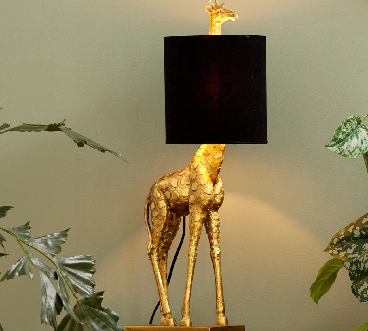 Giraffe Lamp in a gold finish with a black shade