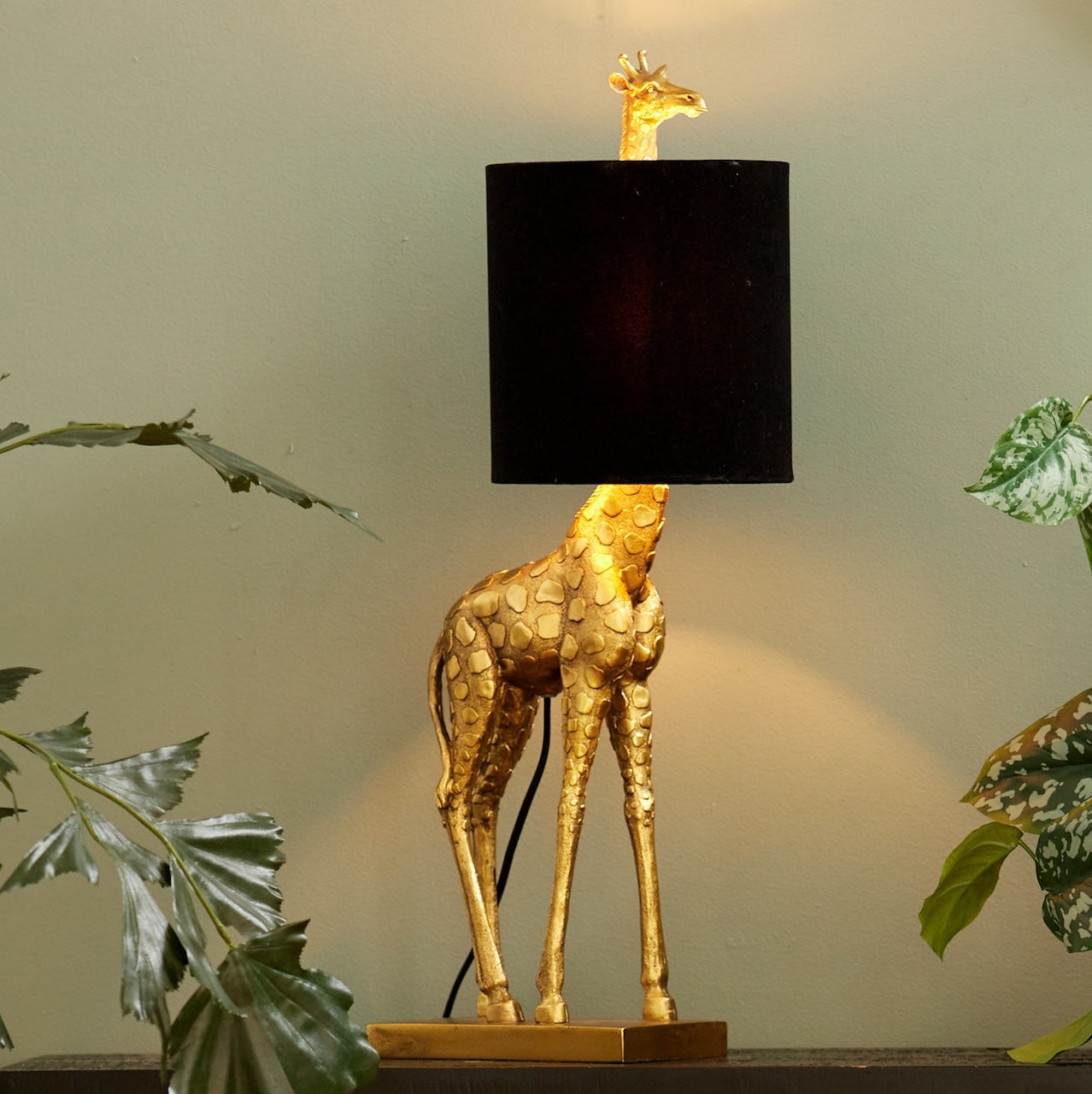 Giraffe Lamp in a gold finish with a black shade