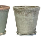 Two ceramic pots with a textured finish on a white background