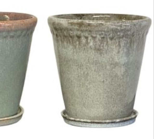 Two ceramic pots with a textured finish on a white background
