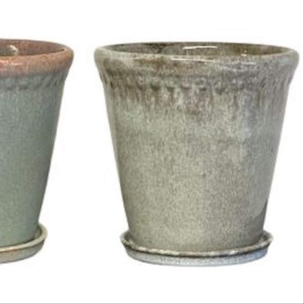 Two ceramic pots with a textured finish on a white background