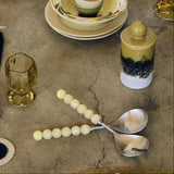yellow bobble salad servers with hkliving 70's crockery on a table 