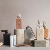 Collection of Vely products including soap bars and containers on a neutral background