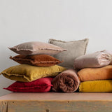 yellow velvet cushion with fringe edging