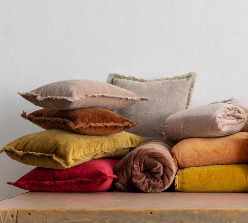 yellow velvet cushion with fringe edging