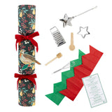 Collection of kitchen items including a cracker, grater, star-shaped cutters, and more on a white background.