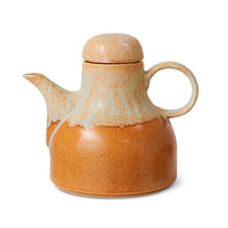 Ceramic teapot with a marbled design on a white background