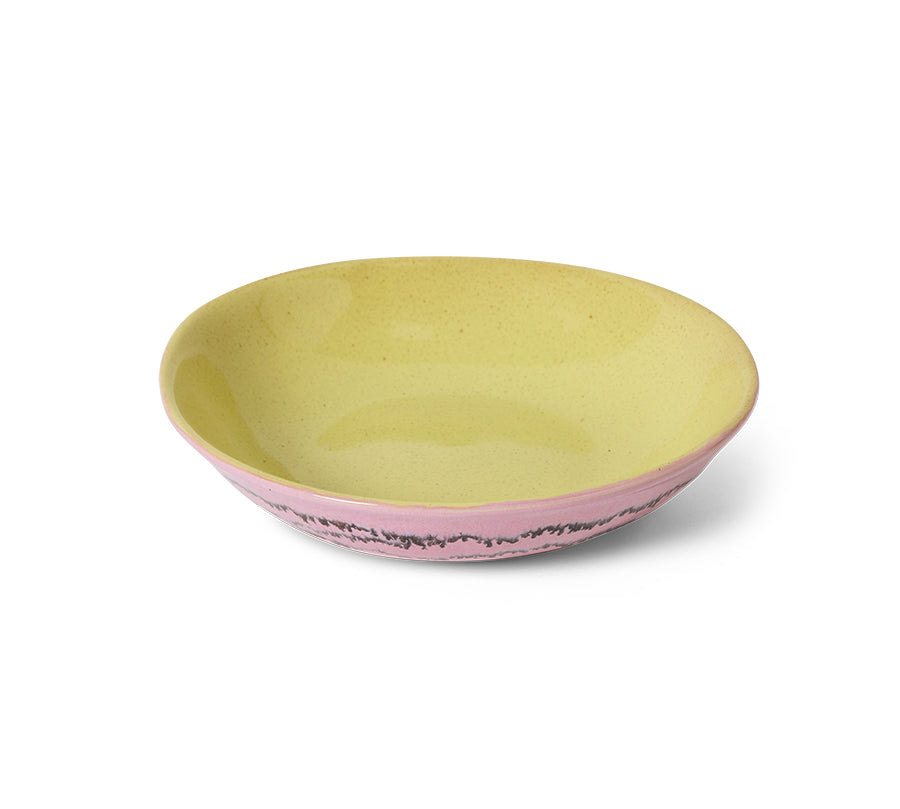 Two-tone ceramic bowl with pink interior and yellow exterior on a white background