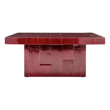 A glossy dark red square coffee table with a tiled top and a textured block base, shown against a plain white background.