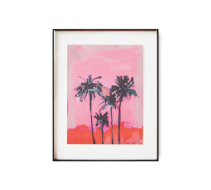 Framed artwork of palm trees against a pink sky on a white background