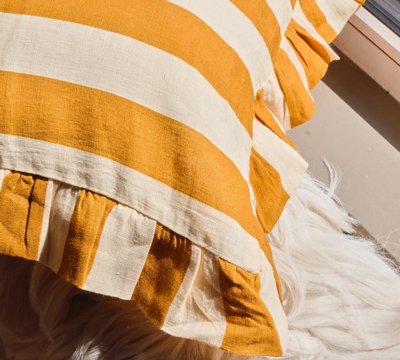 Close-up of a orange and beige striped fabric cushion