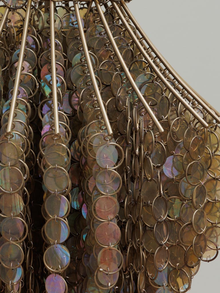 Close-up of a decorative item with circular metallic elements on a plain background