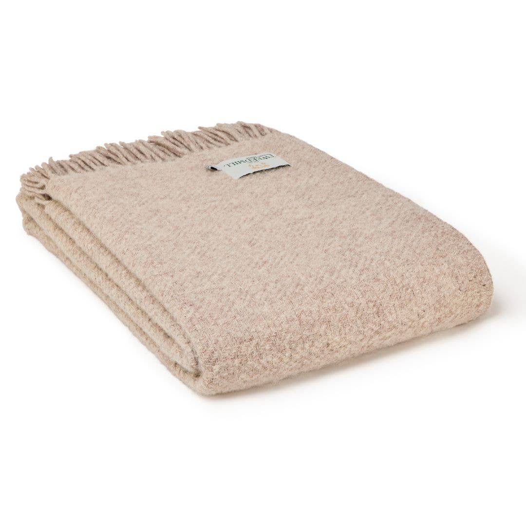 Beige blanket with a brand label on a white background