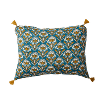Decorative pillow with floral pattern and tassels on a white background