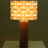 Decorative table lamp with a patterned shade on a dark background