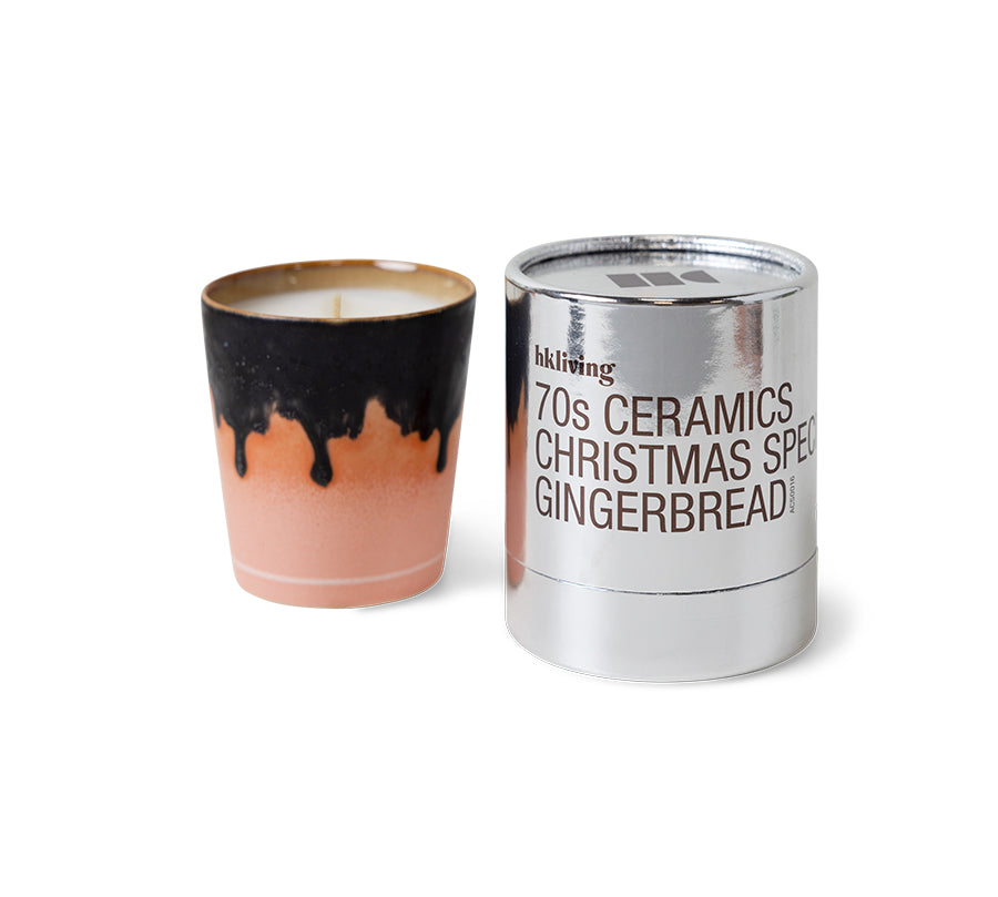 Candle with gradient design and a metallic container labeled '70s Ceramics Christmas Special Gingerbread' on a white background.