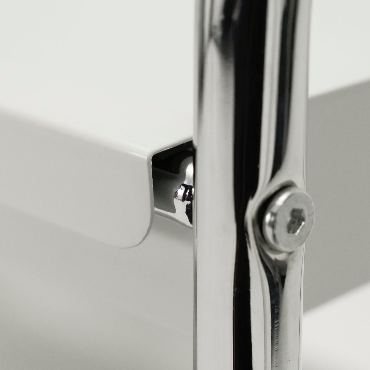Close-up of a metallic shelf joint with reflective surface