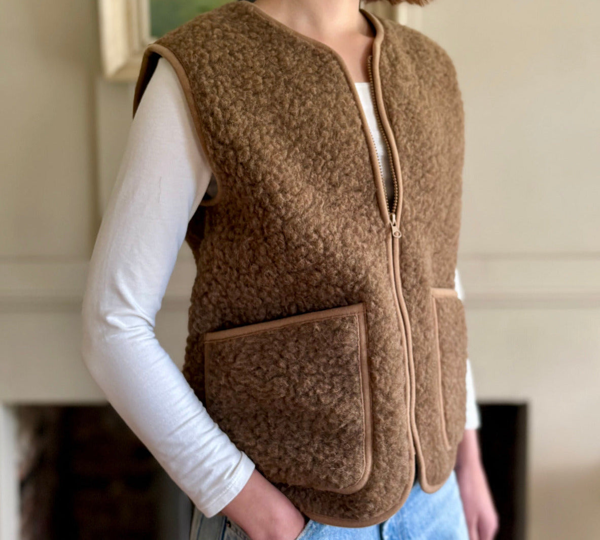 woman wearing a brown fleece wool vest indoors