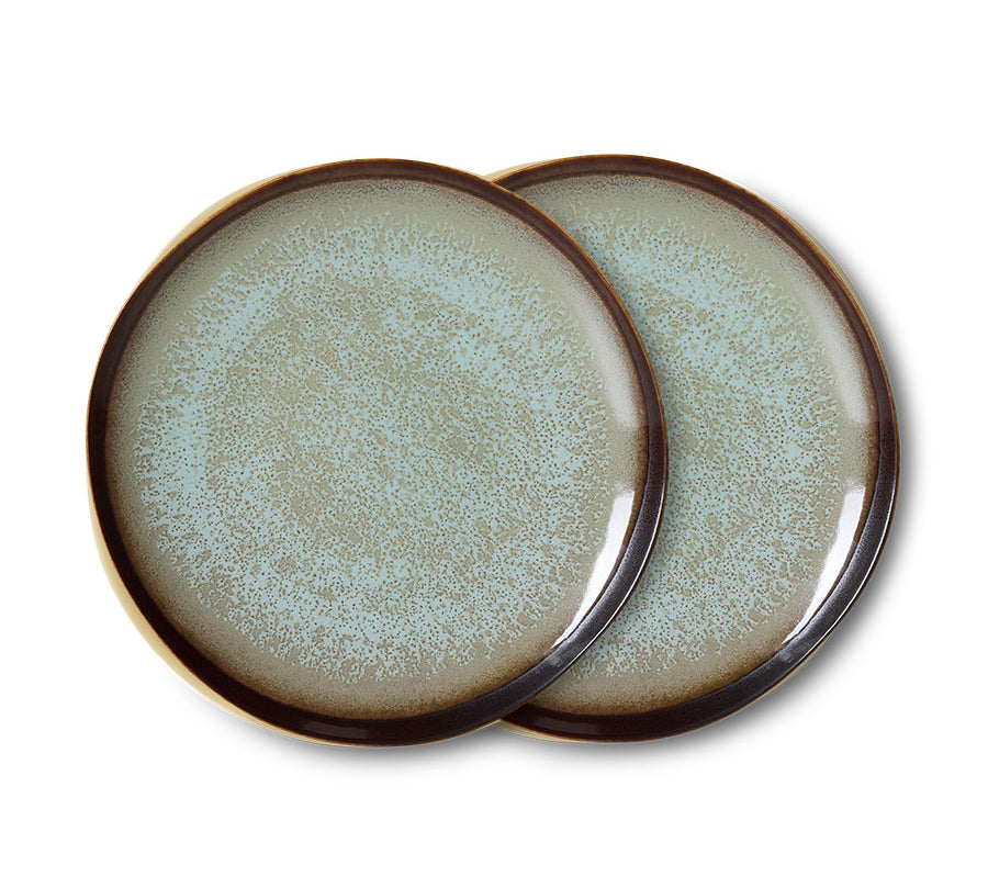Two ceramic plates with a textured surface and brown rim on a white background