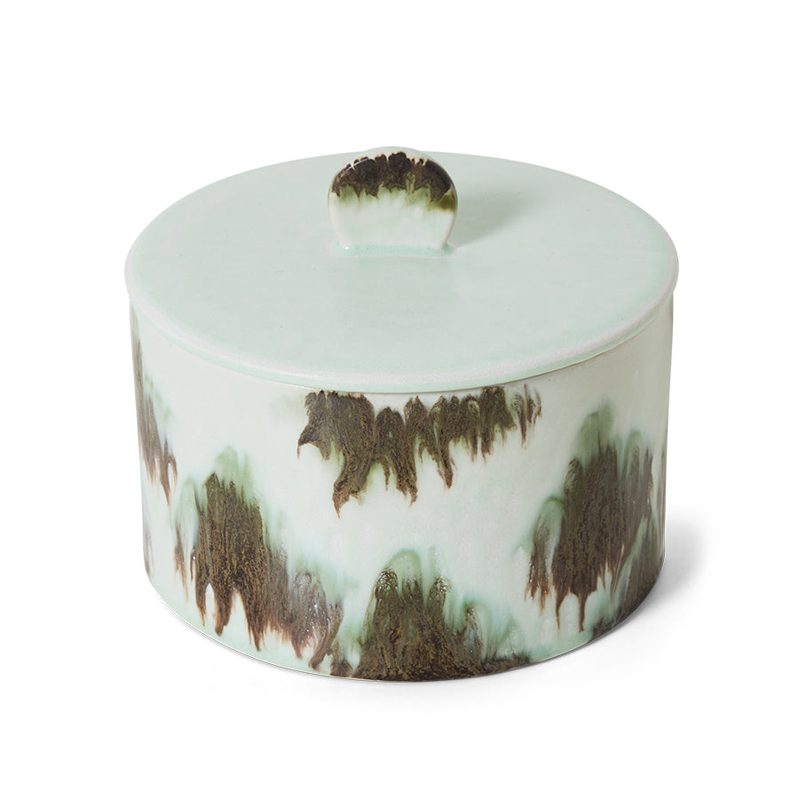 Decorative ceramic container with a lid on a white background