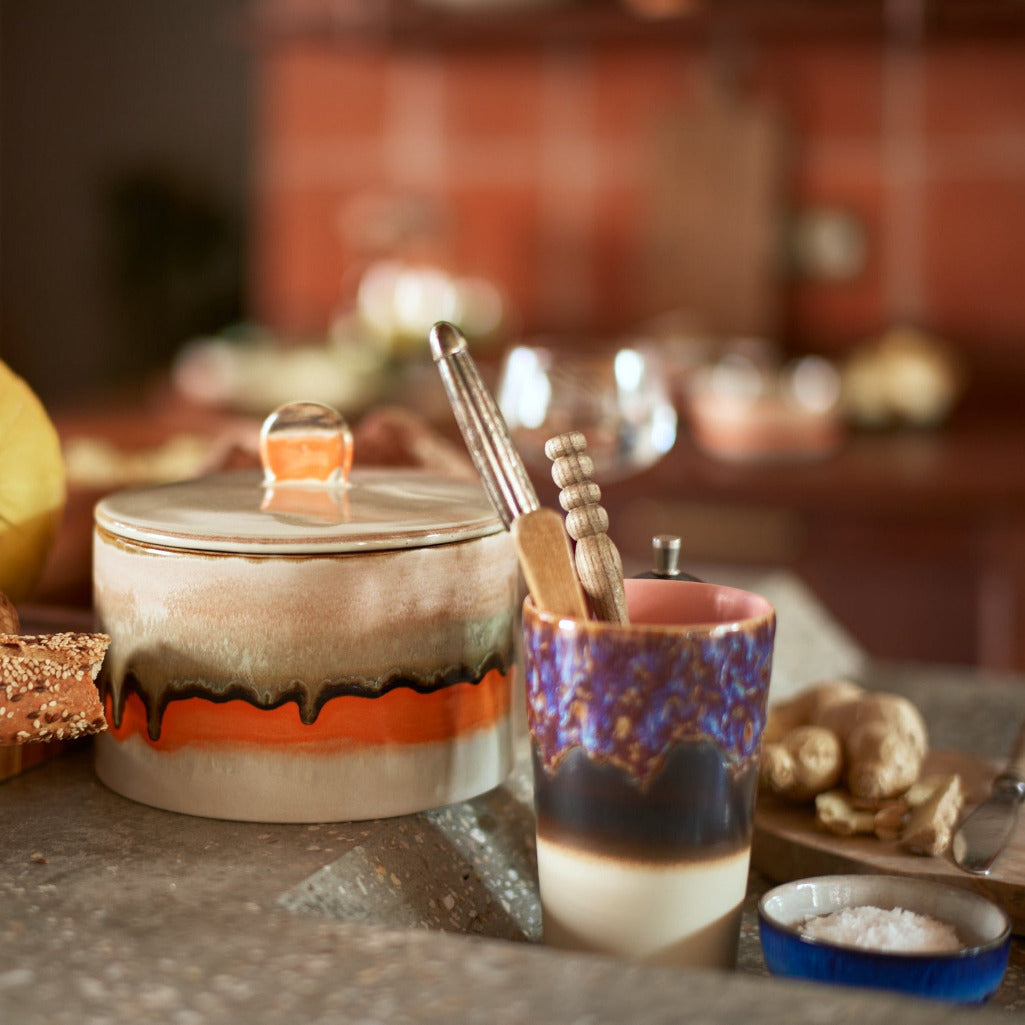 Ceramic jar with colorful design on a kitchen counter