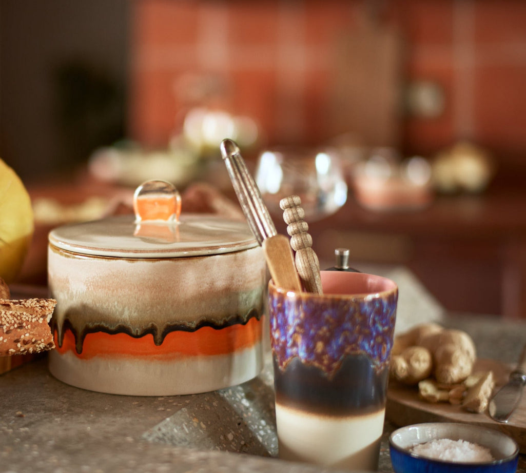Ceramic jar with colorful design on a kitchen counter
