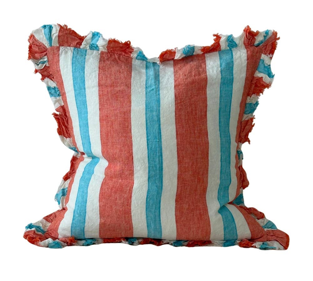 Coral stripe stonewashed linen cushion with fringe ruffle edge on white background, showing coral, aqua and white vertical stripe pattern