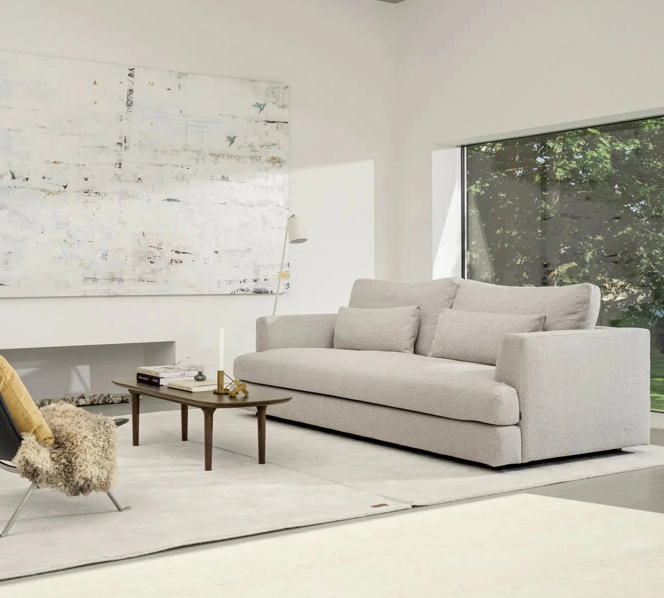 Modern living room with a gray sofa, chairs, and a coffee table.