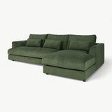 Green velvet sectional sofa on a white background
