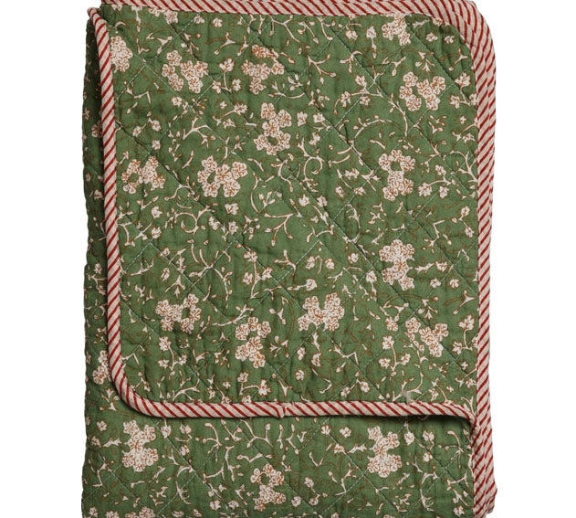Green floral quilt with red and white striped border on a white background