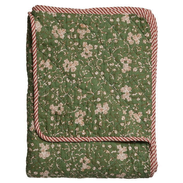 Green floral quilt with red and white striped border on a white background