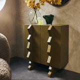 Modern interior with an olive green side table, round mirror, and yellow flowers.