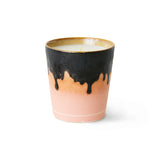 Ceramic candle with black drip design on a white background