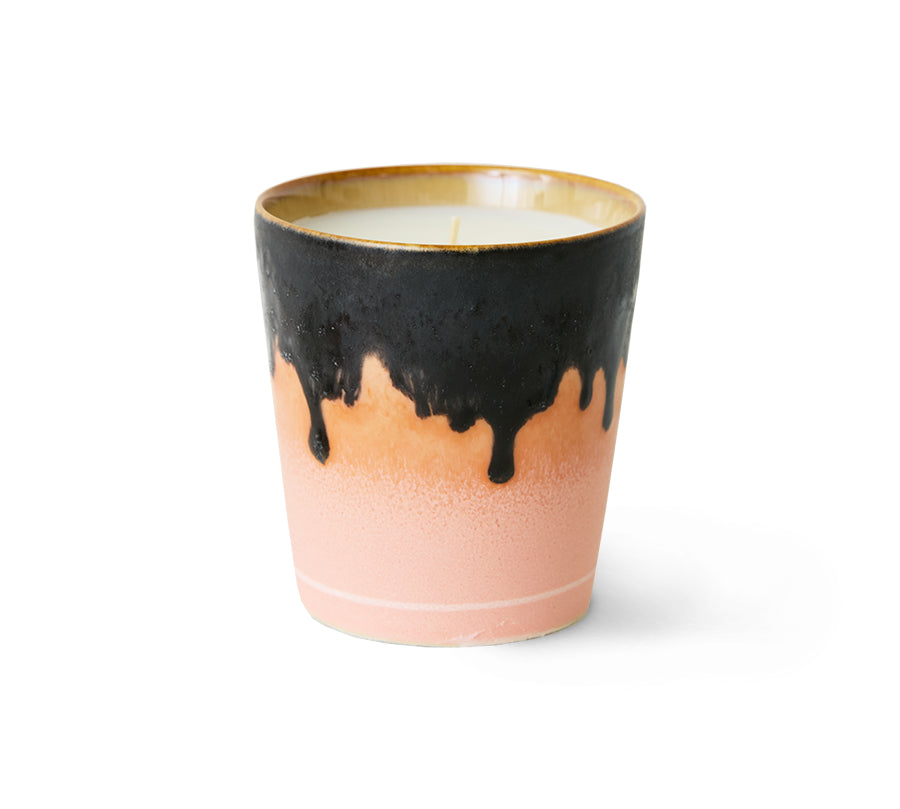 Ceramic candle with black drip design on a white background