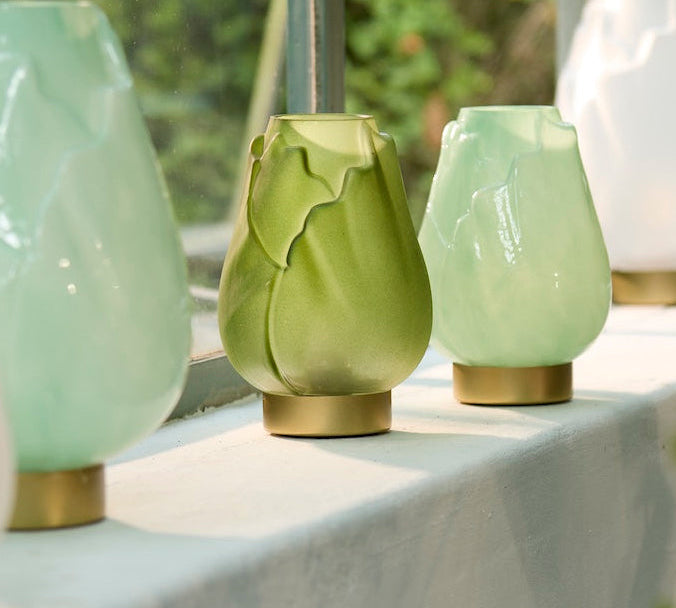 Set of decorative table lamps on a table with a blurred natural background