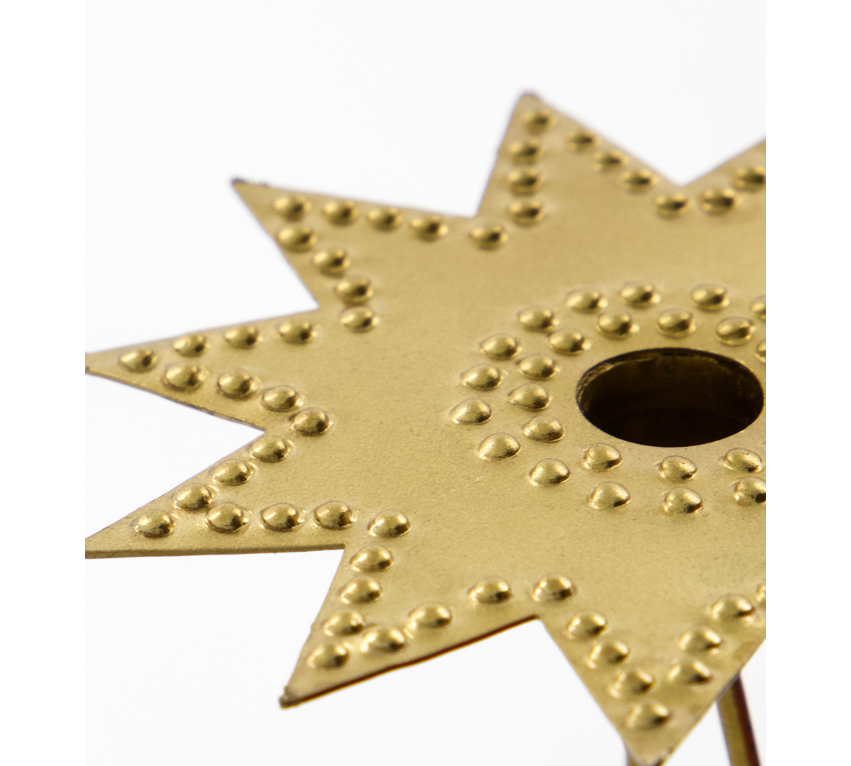 Gold star-shaped candle holder with textured surface on a white background