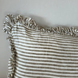Striped fabric with ruffled edge on a plain background