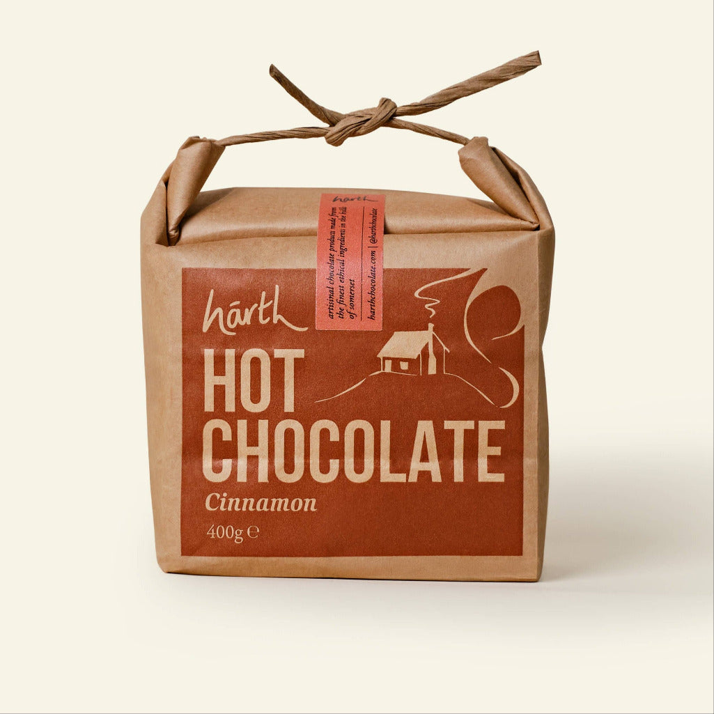Box of Härth Hot Chocolate with cinnamon flavor on a beige background