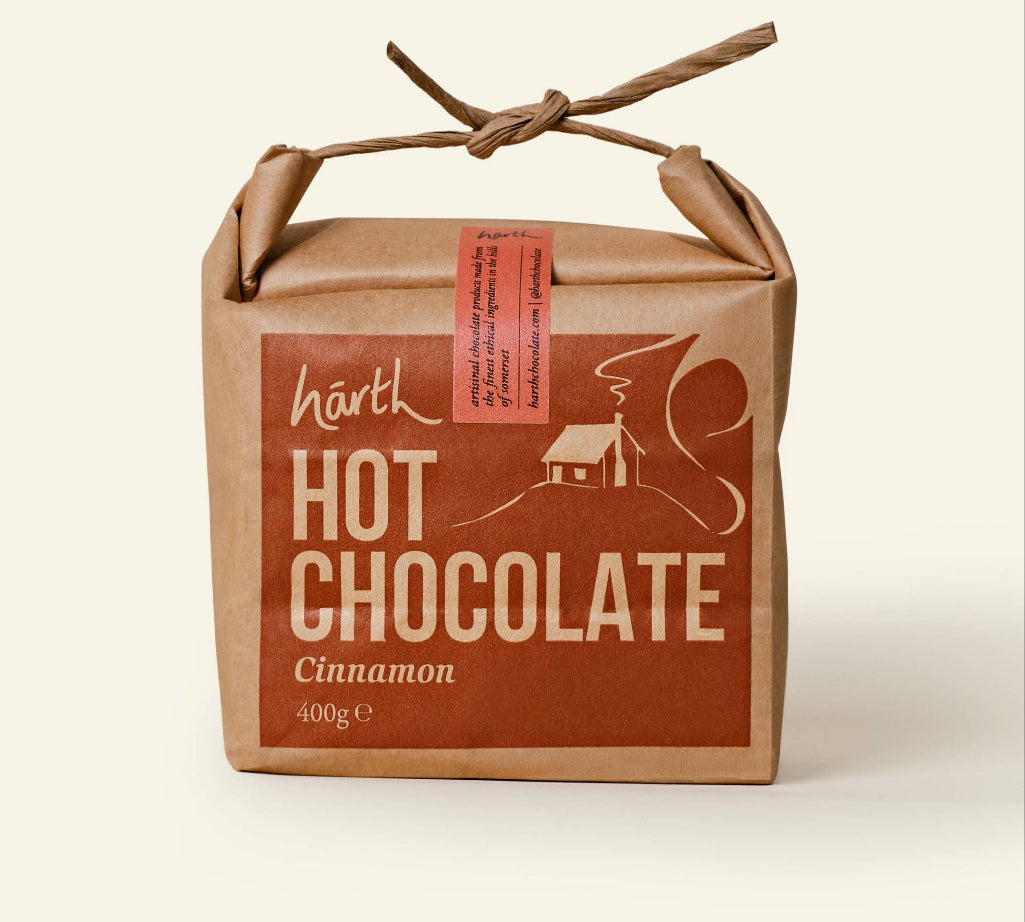 Box of Härth Hot Chocolate with cinnamon flavor on a beige background