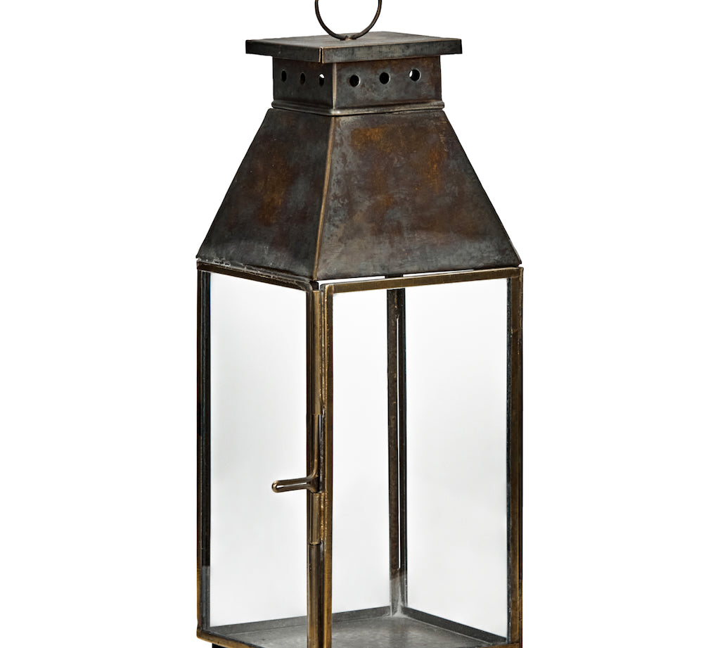 Decorative lantern with a metal top and glass body on a white background