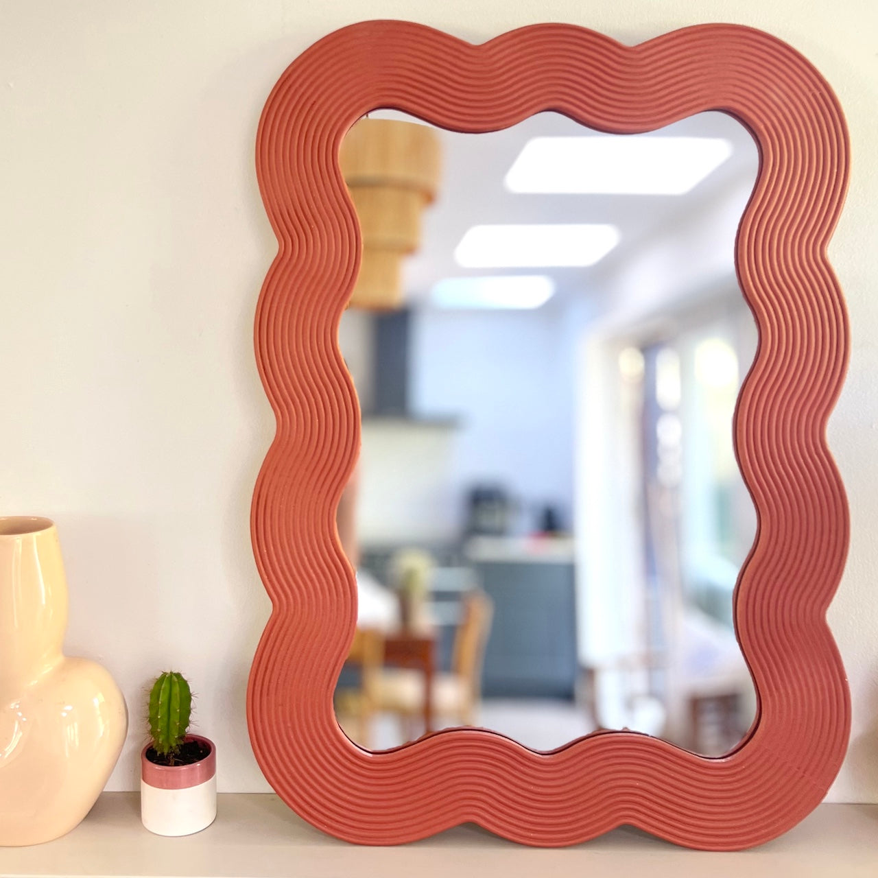 red wooden mirror
