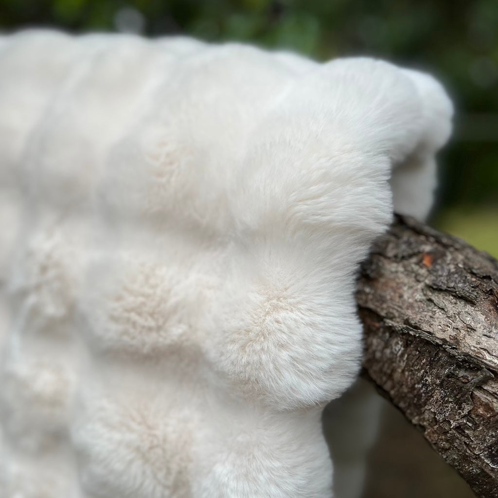 close up of white faux fur throw