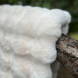 close up of white faux fur throw