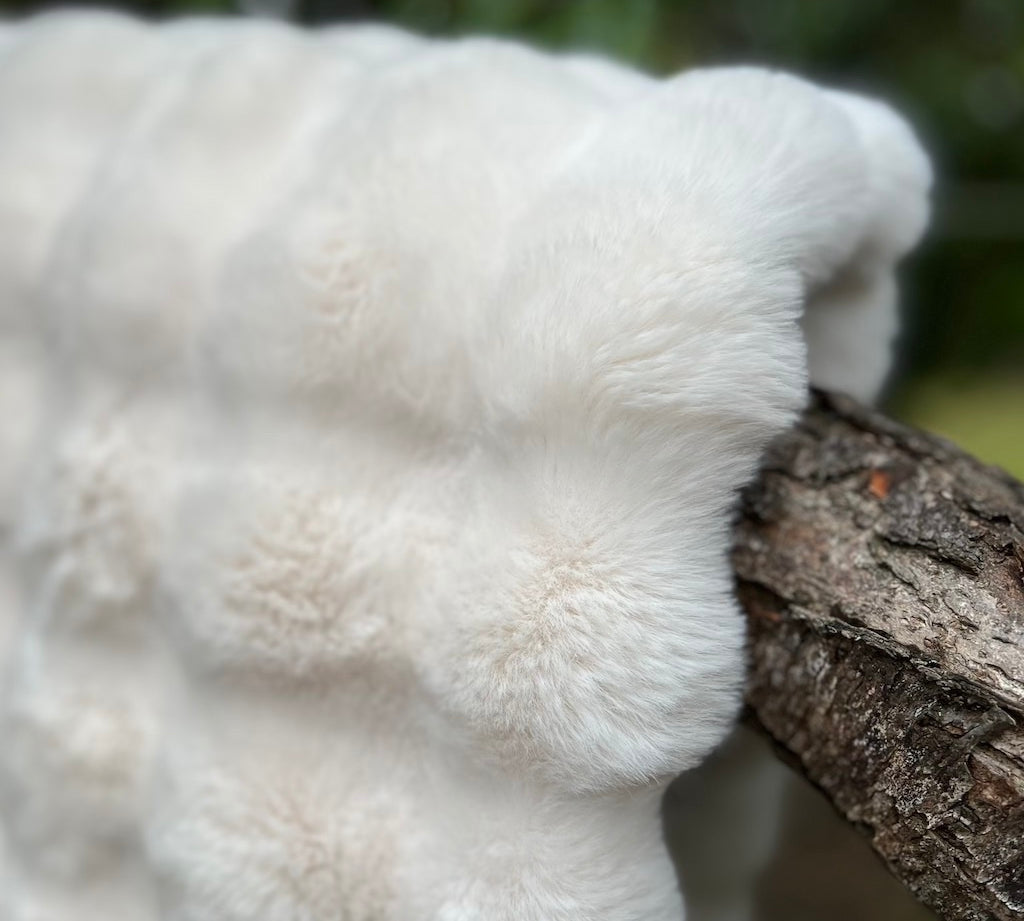 close up of white faux fur throw